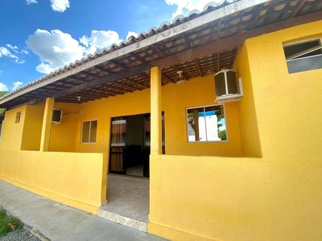 a yellow house with a window and a door at Casa Condomínio Beira Rio in Canindé de São Francisco