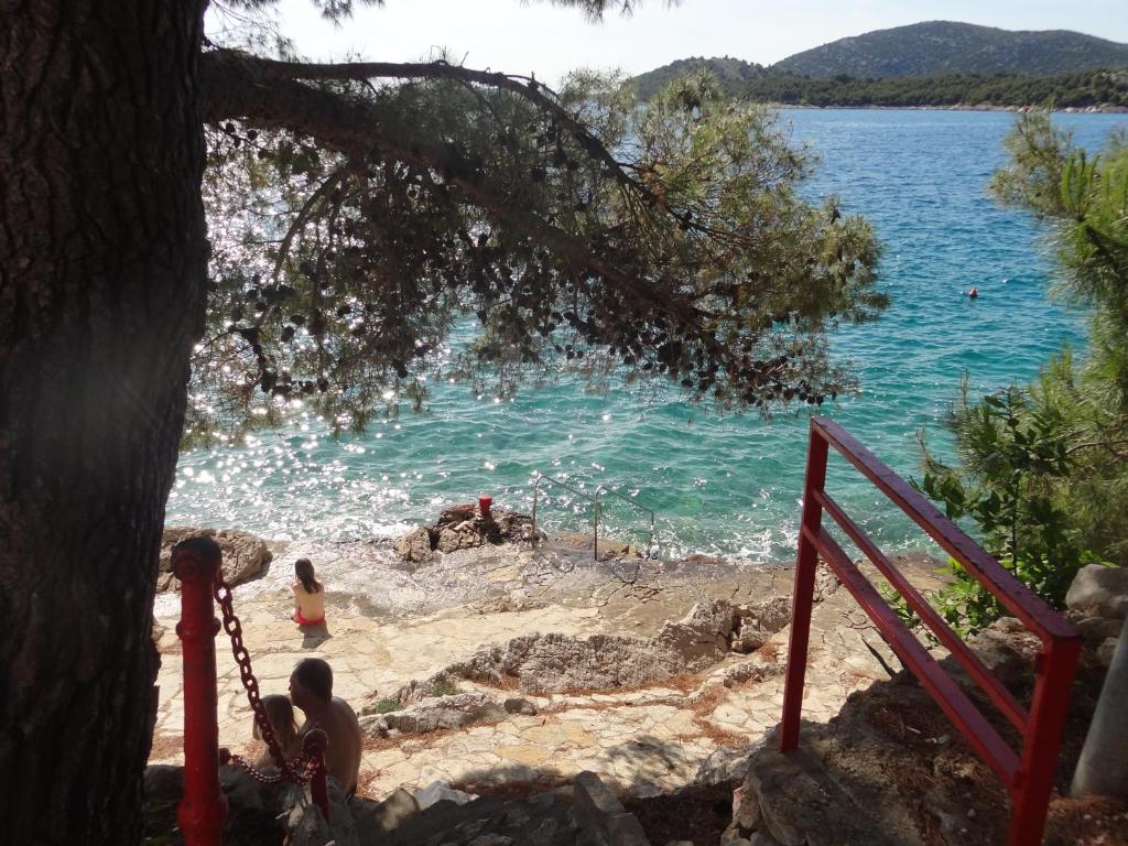 a group of people on a beach near the water at Villa Ela in Tribunj