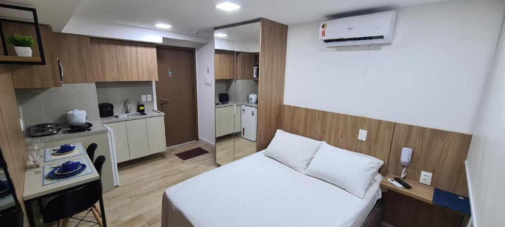 Habitación pequeña con cama y cocina en Apartamentos Decorados Próximos mar en João Pessoa