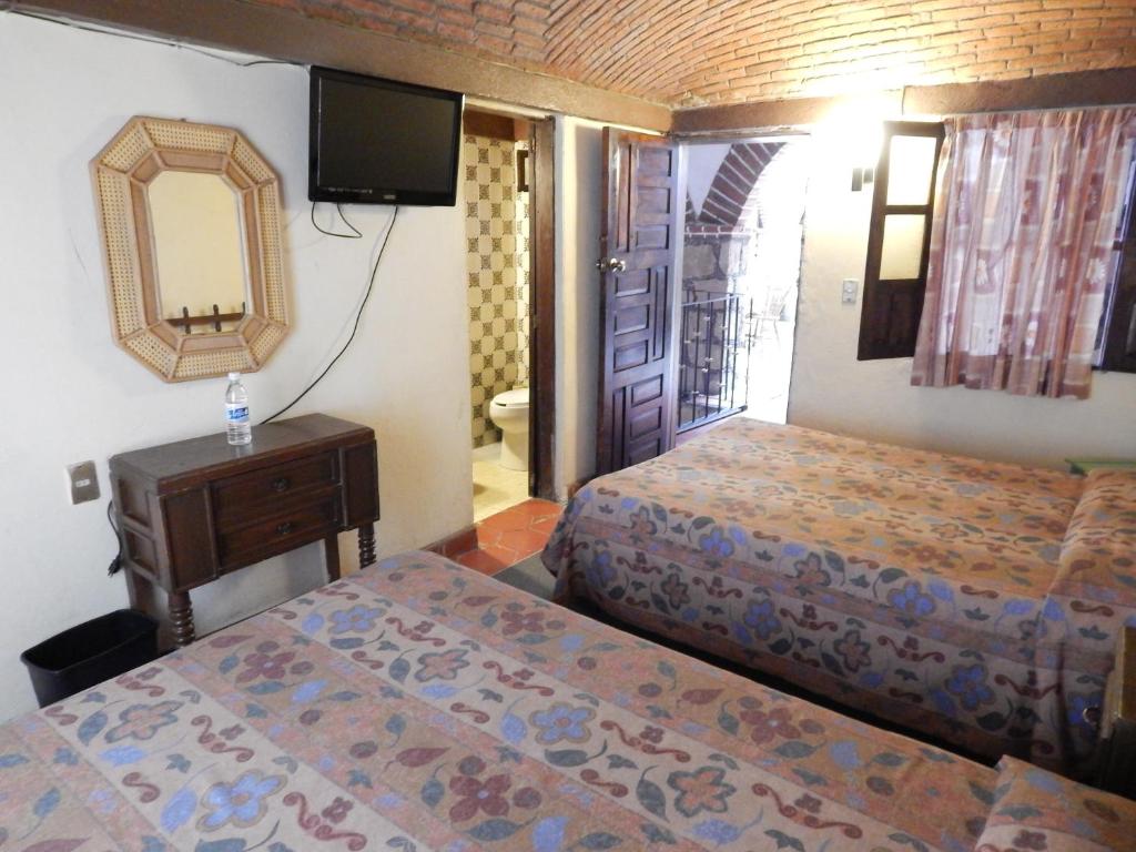 Postel nebo postele na pokoji v ubytování Hotel Molino del Rey