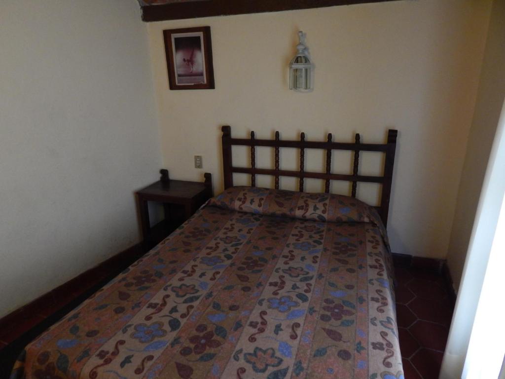 Postel nebo postele na pokoji v ubytování Hotel Molino del Rey