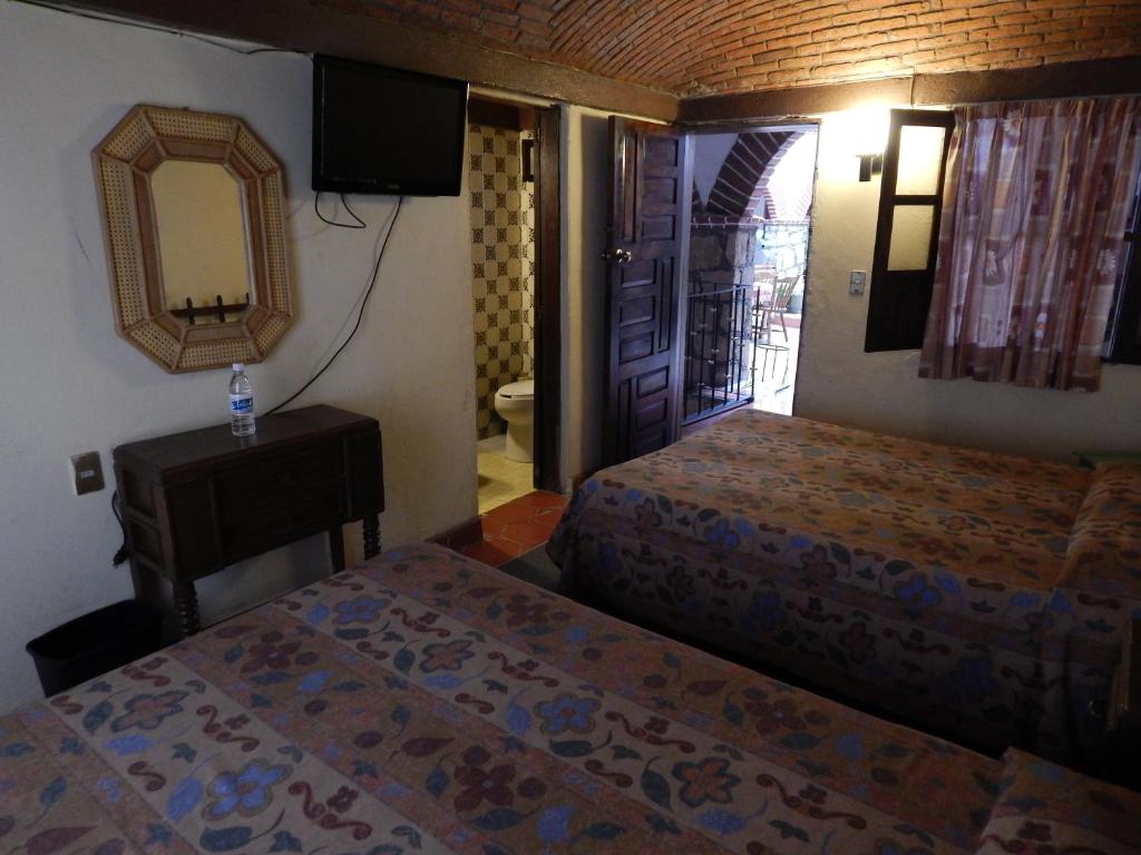 Postel nebo postele na pokoji v ubytování Hotel Molino del Rey