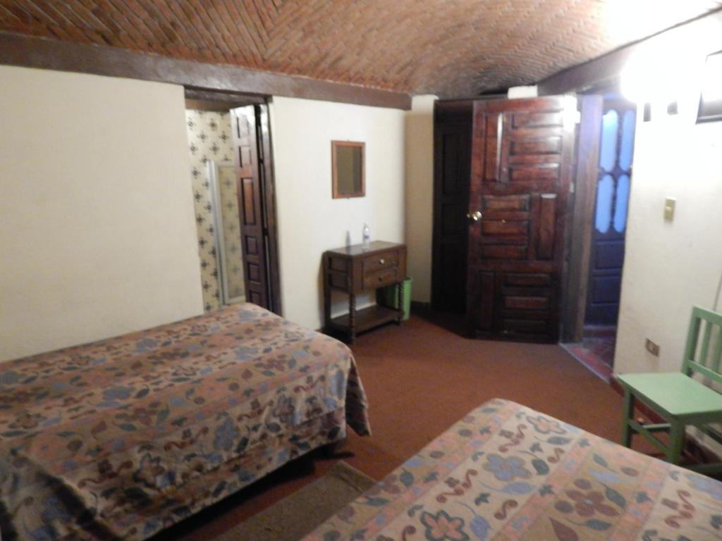 Postel nebo postele na pokoji v ubytování Hotel Molino del Rey