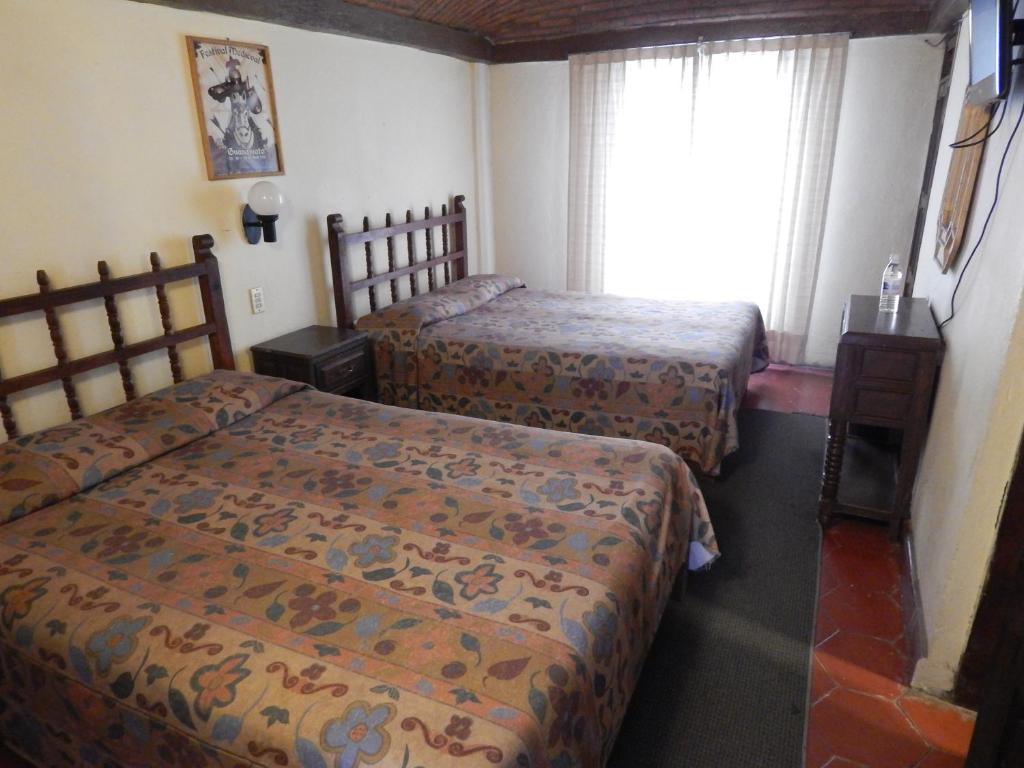 Postel nebo postele na pokoji v ubytování Hotel Molino del Rey