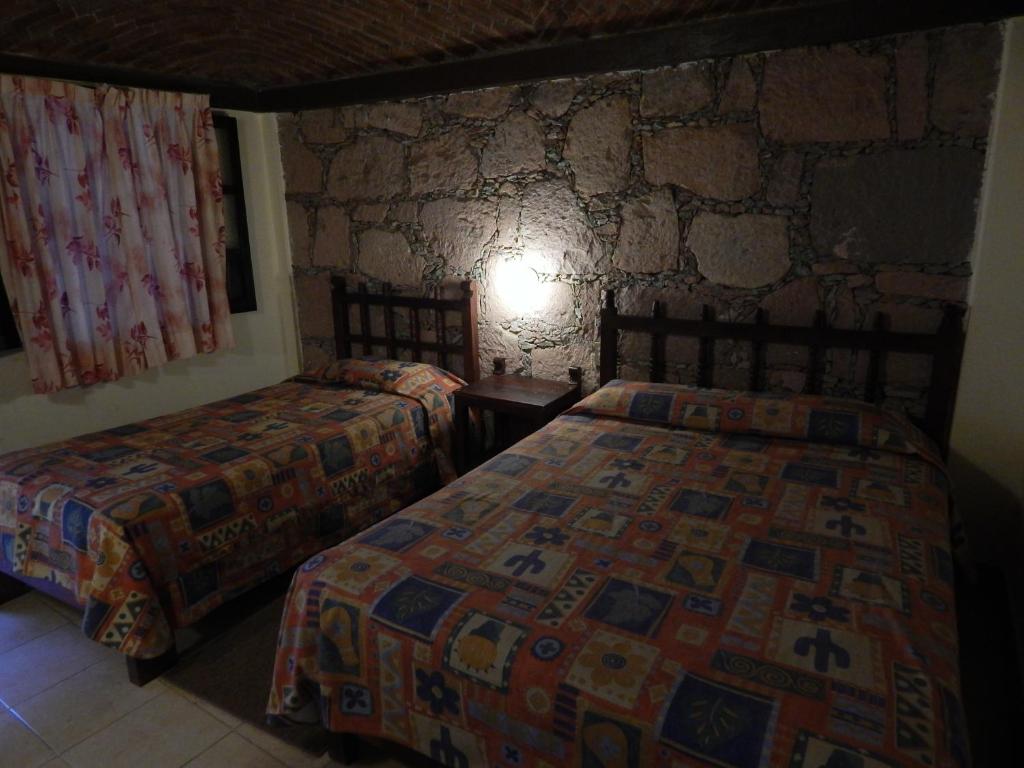 Postel nebo postele na pokoji v ubytování Hotel Molino del Rey