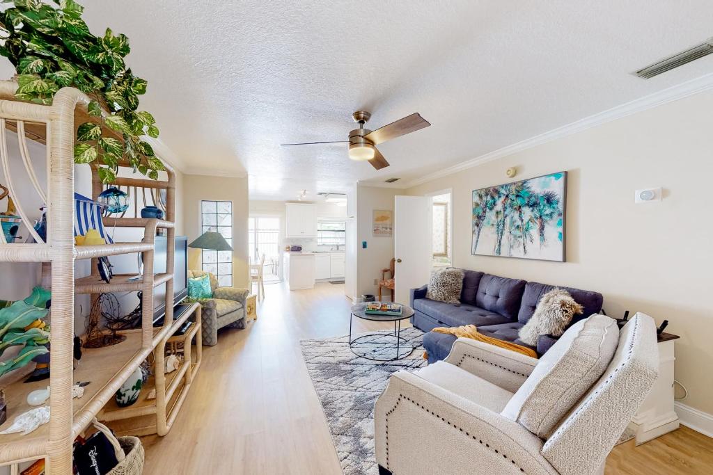a living room with a couch and a table at The Shuttle Beach House in Cape Canaveral