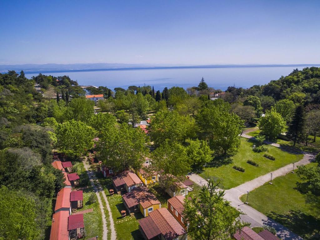 an aerial view of a village with trees and the ocean at Modern chalet with two bathrooms, 9 km south of Opatija in Medveja
