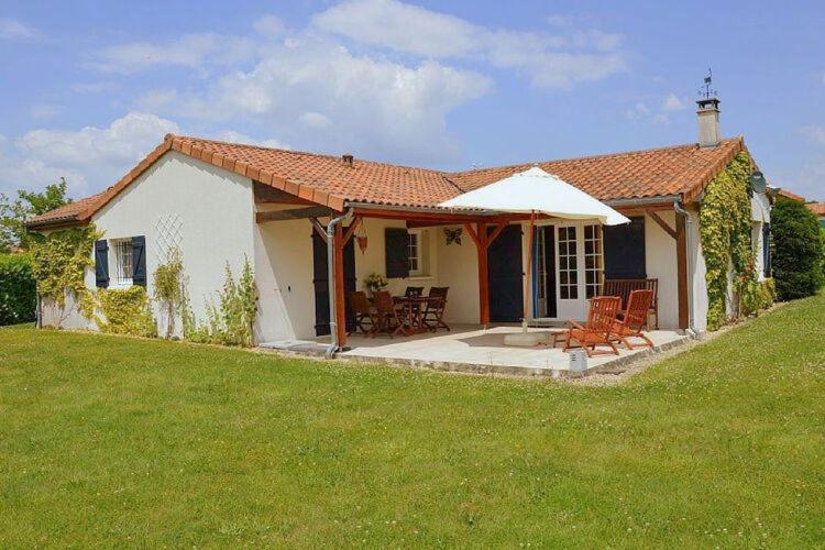 a small white house with a lawn in front of it at Luxury Villa in France with Pool in Vasles