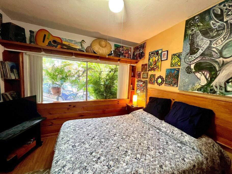a bedroom with a large bed and a window at Miami Bungalow Oasis near Everglades & The Keys in Cutler Bay