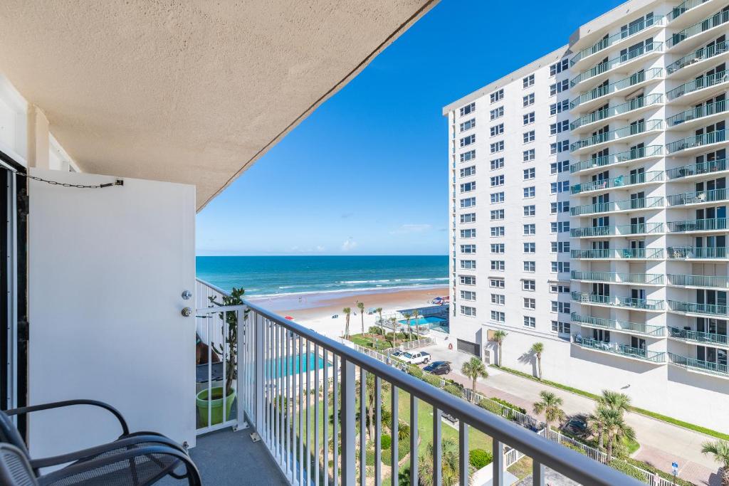 a balcony with a view of the beach and buildings at MCM Retro Beachfront Studio Great View, King Bed Remodeled in Daytona Beach