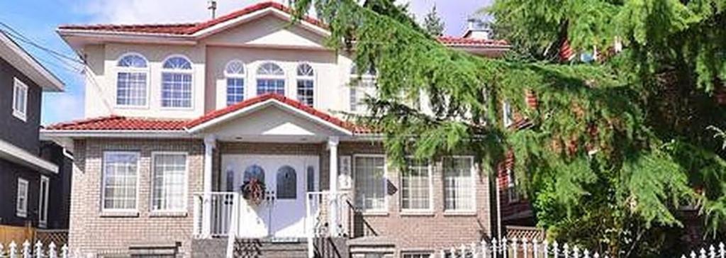 a house with a white fence in front of it at Beautiful Home in Burnaby (Metrotown Area) in Burnaby