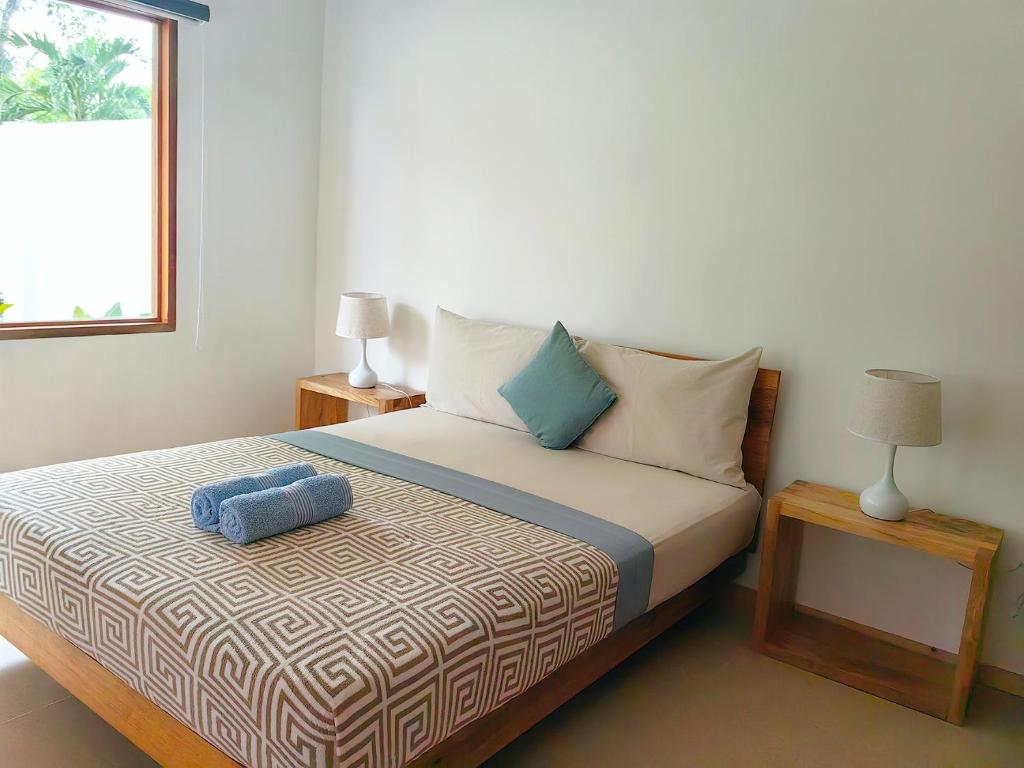 Postel nebo postele na pokoji v ubytování Island World Panglao