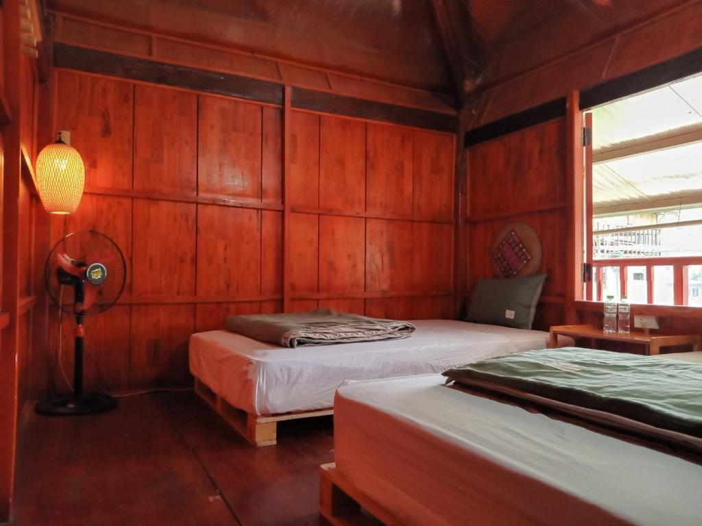 a bedroom with two beds and a lamp in it at Eco Joville House - Sapa Homestay in Sa Pa