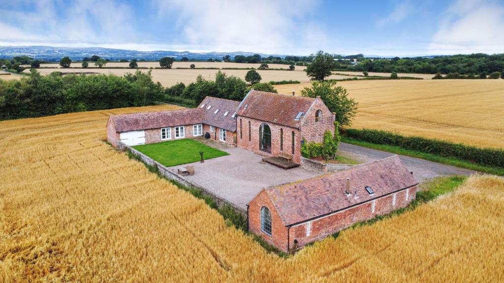 an aerial view of an old house in a field at Windy Mundy Farm in Shrewsbury