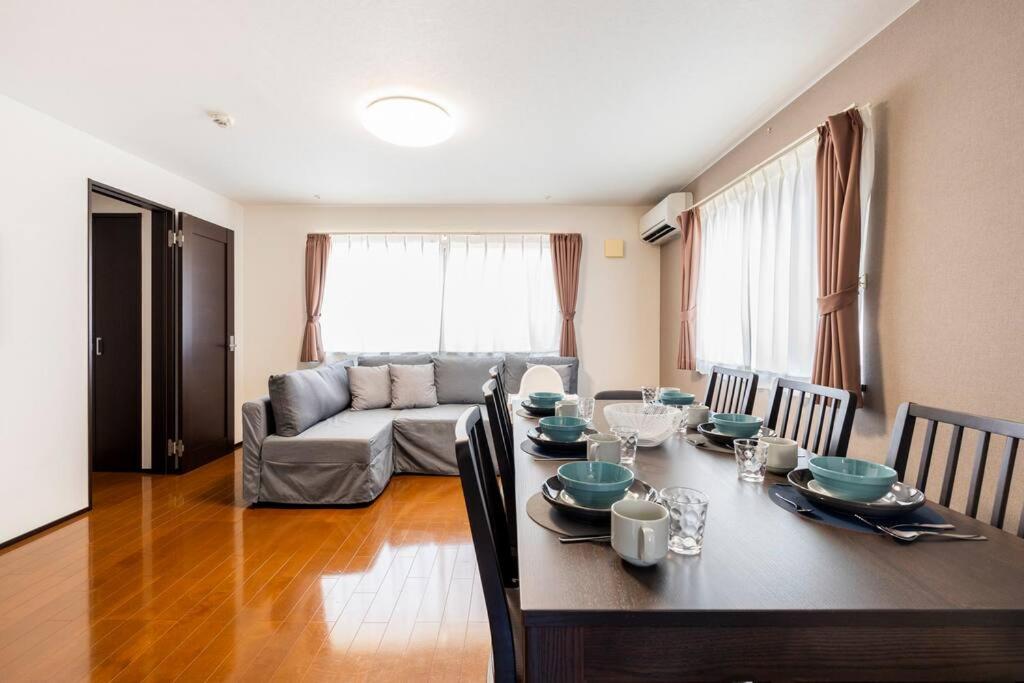 a living room with a table and a couch at FUJIMI TOWN HOUSE in Tokyo