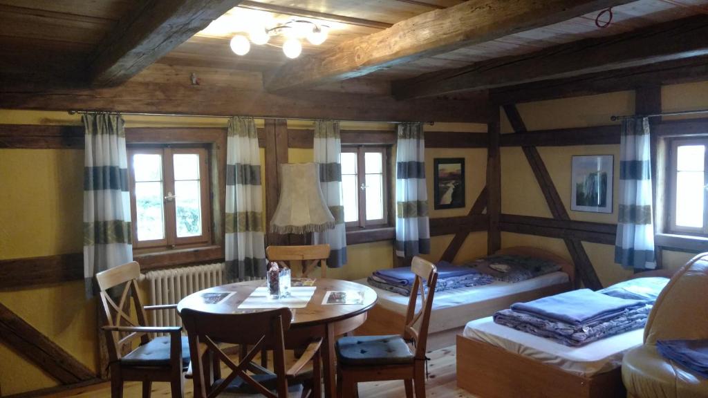 a room with a table and a bed and a bedroom at NaturflairHaus in Königstein an der Elbe