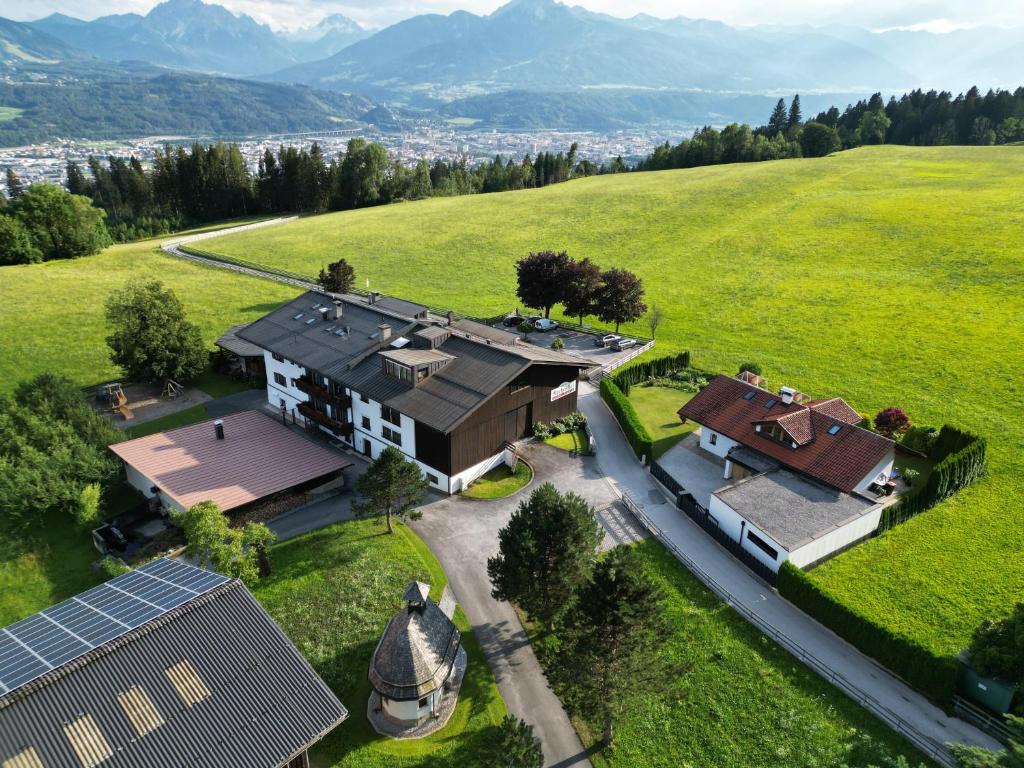 an aerial view of a house in a field at Gasthof Rechenhof in Innsbruck