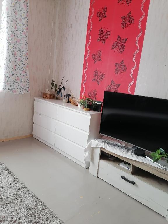 a living room with a tv and a white dresser at Kodune majutus in Viljandi