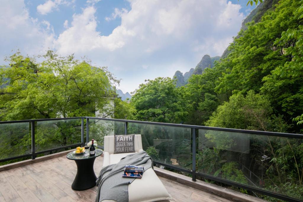 a balcony with a view of the mountains at Garden Villa Resort Yangshuo in Yangshuo