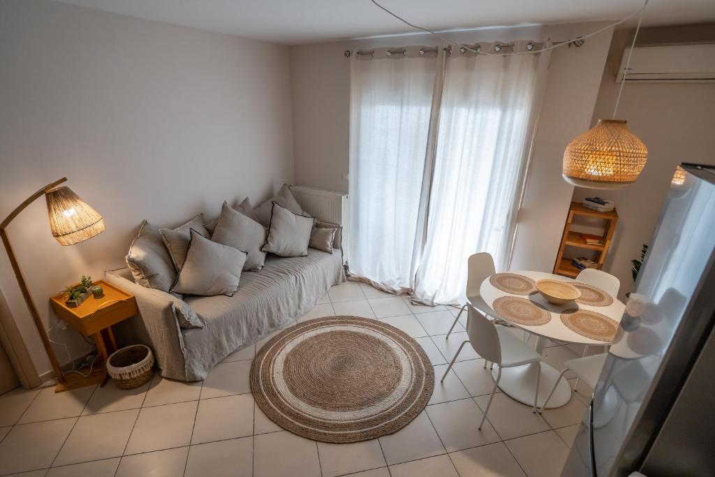 a living room with a couch and a table at Elia Family Apartment in Neos Marmaras