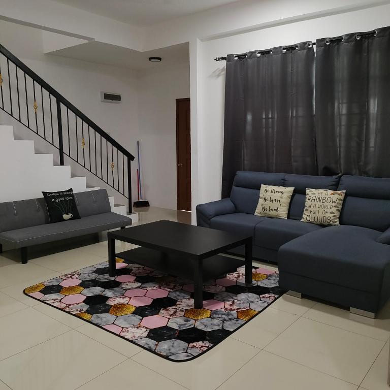 a living room with a couch and a coffee table at Ummik Homestay in Tawau