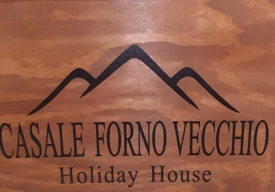 a sign for a holiday house with a mountain at Casale Forno Vecchio in Tramonti