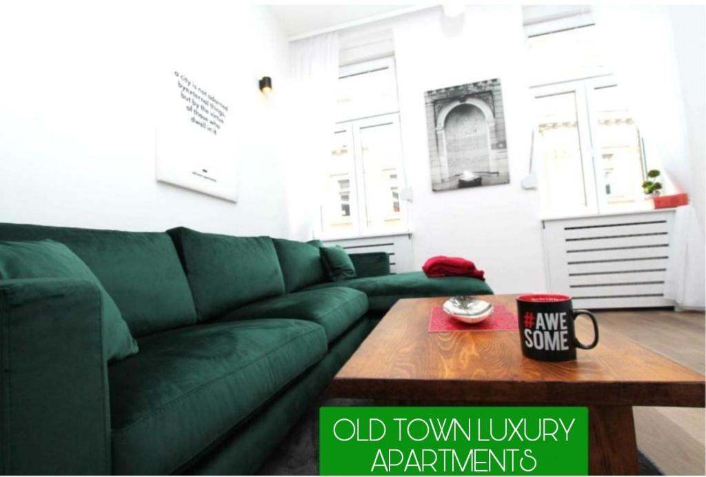 a green couch in a living room with a coffee table at Old Town Luxury Apartments in Sarajevo