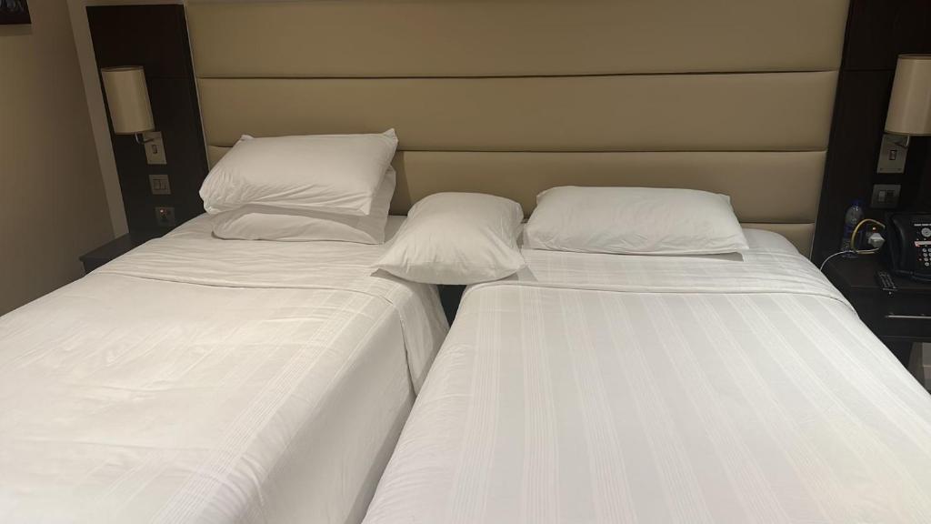 two beds sitting next to each other in a room at Perfect Stay Dubai in Dubai