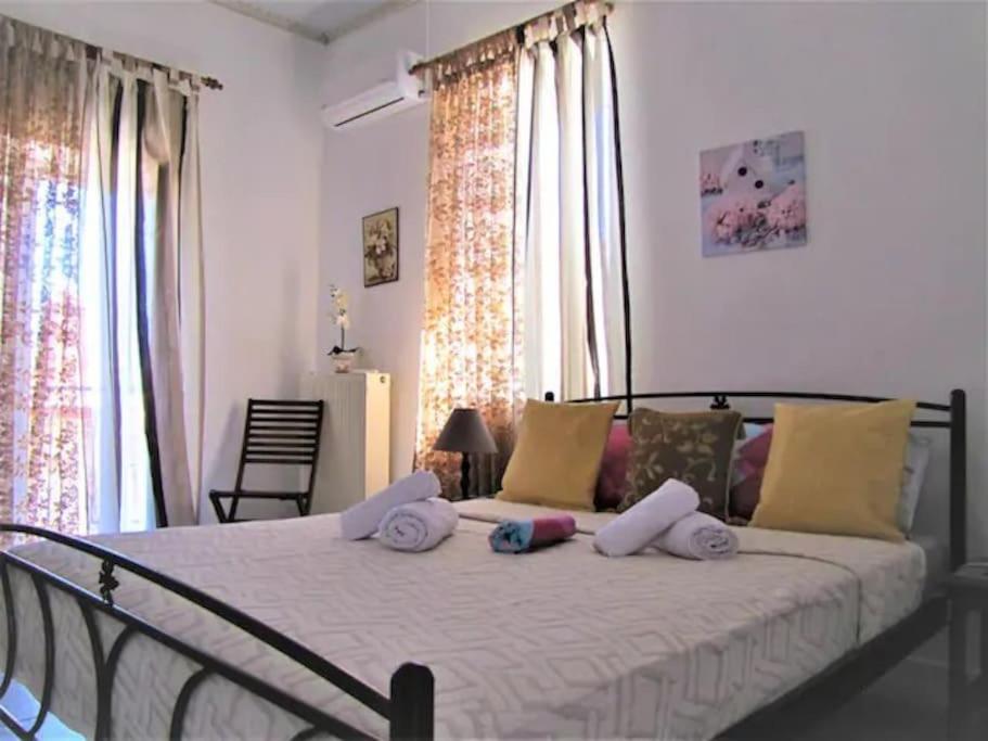 a bedroom with a large bed with pillows on it at Toula's Garden-View Apartment 3 in Moúdhros