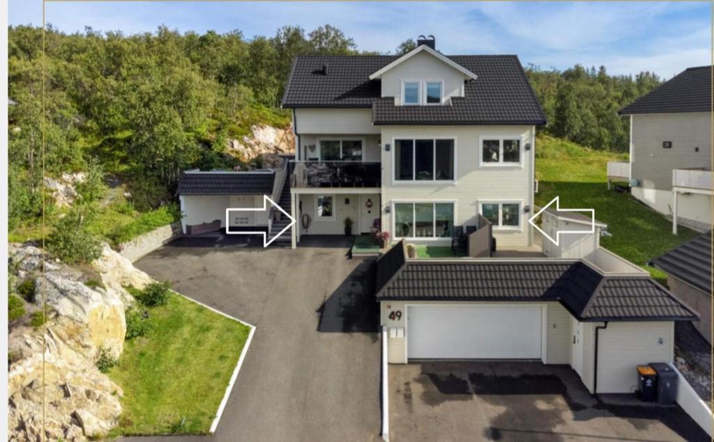 an aerial view of a house with a driveway at Aurora apartment in Kvaloya Tromso in Tromsø