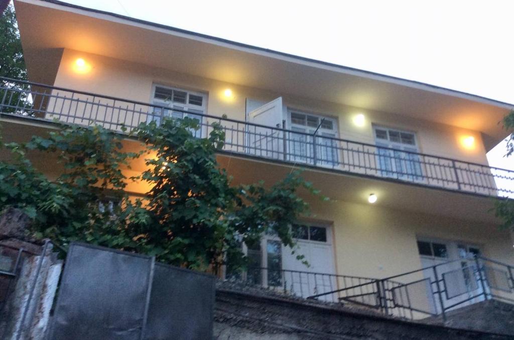 a building with a balcony with lights on it at Комната с видом на горы in Dilijan