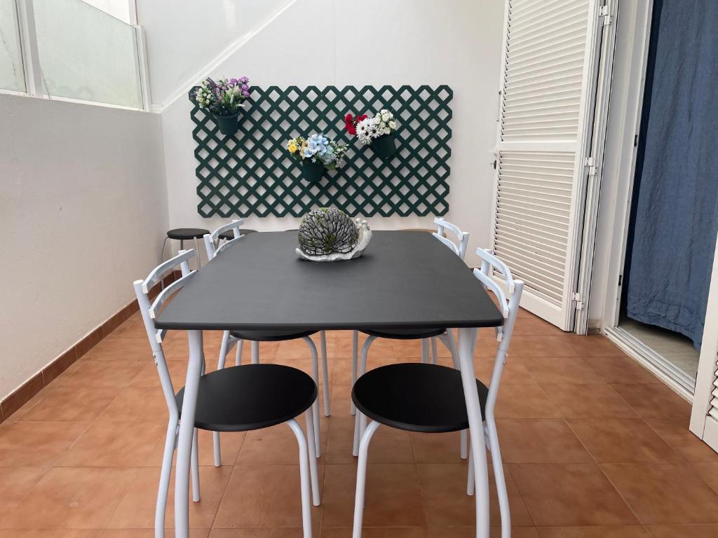 a black table and chairs in a room at Apartamento casa típica canaria in Playa Honda
