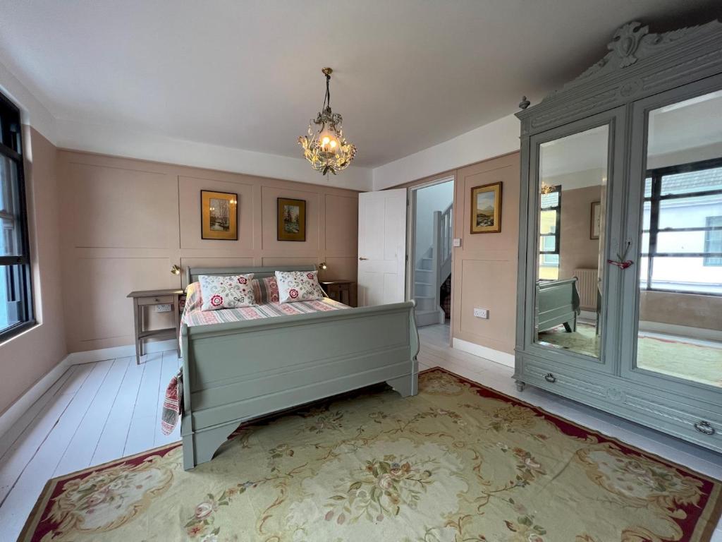 a bedroom with a bed and a chandelier at Pass the Keys Sea Haven Stylish Beach Oasis in Hastings