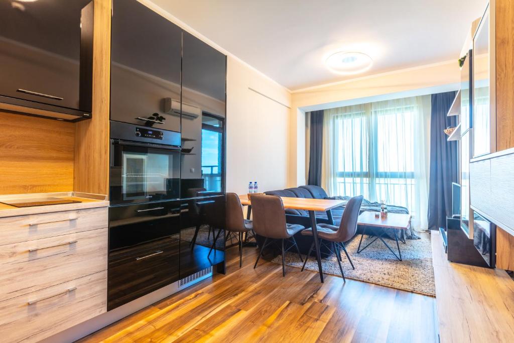 a kitchen and dining room with a table and chairs at Burgas Residence 809 in Burgas City