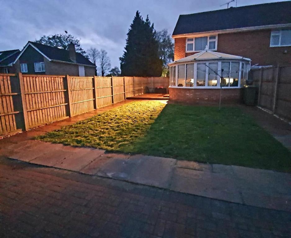 a backyard with a fence and a gazebo at 3 Bedrooms spacious house in Calcot , Reading in Tilehurst