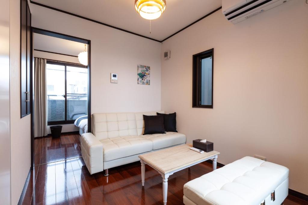 a living room with a white couch and a table at City center Shibuya -都心縁渋谷- in Tokyo