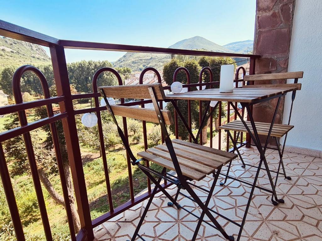 a table and chairs on a balcony with a view at Hostal Lóbrega in Torrecilla en Cameros