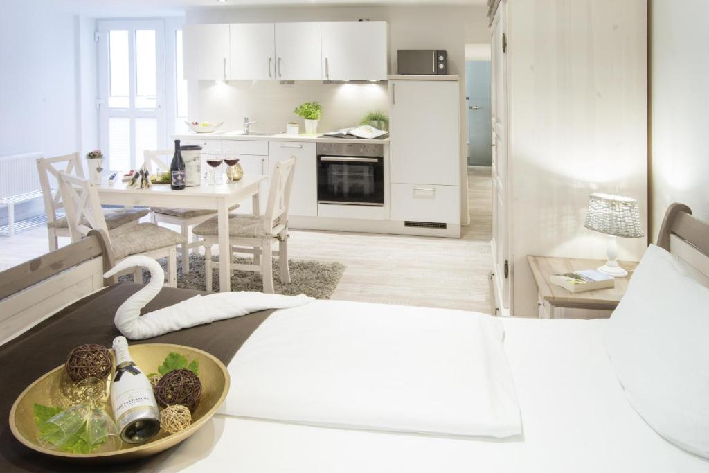 a kitchen and living room with a table with food on it at Biberburg in Flensburg