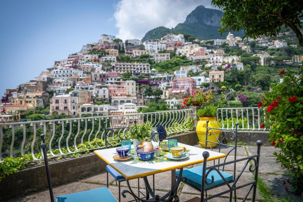 a table and chairs with a view of a city at Villa Dalu in Positano