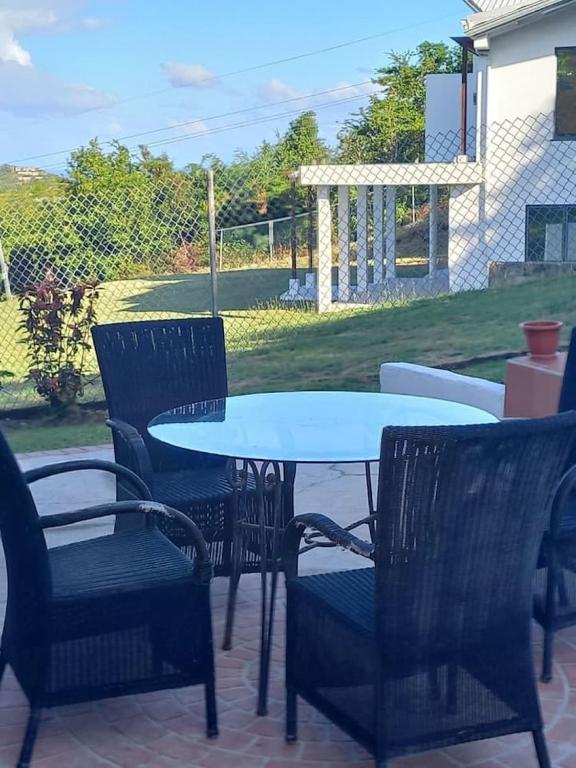 a white table and chairs on a patio at BelleAir Views in Gros Islet