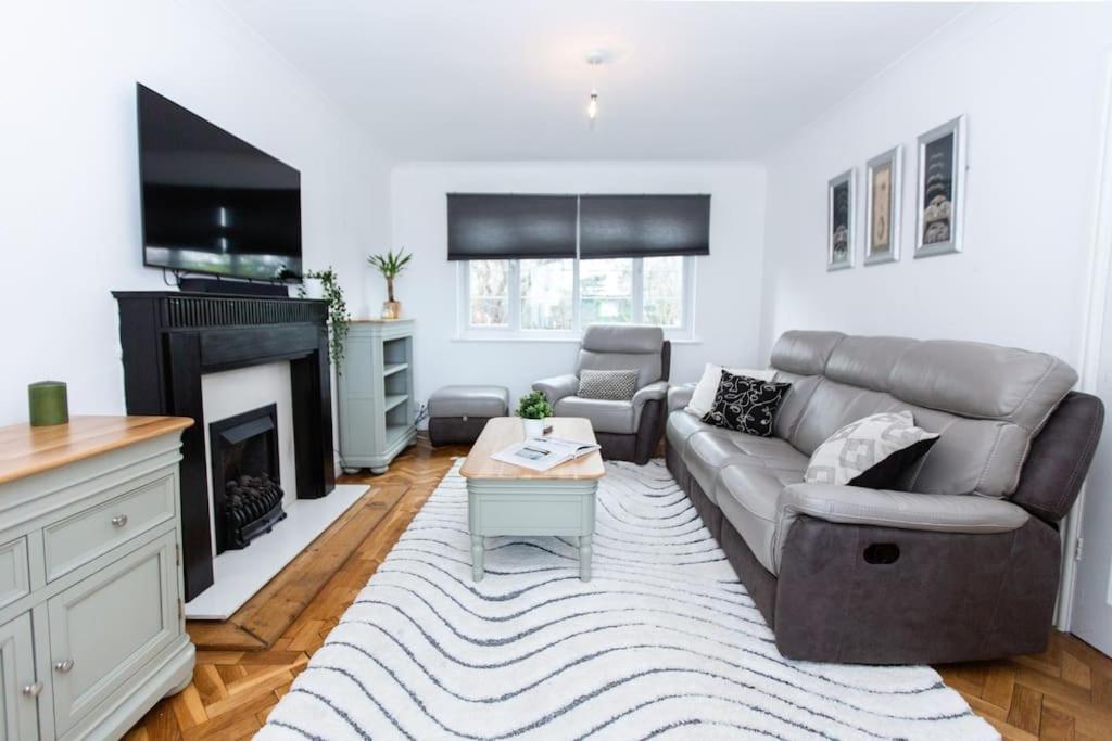 a living room with a couch and a fireplace at Charming 3-Bed Retreat, Excellent Locaton in Nottingham