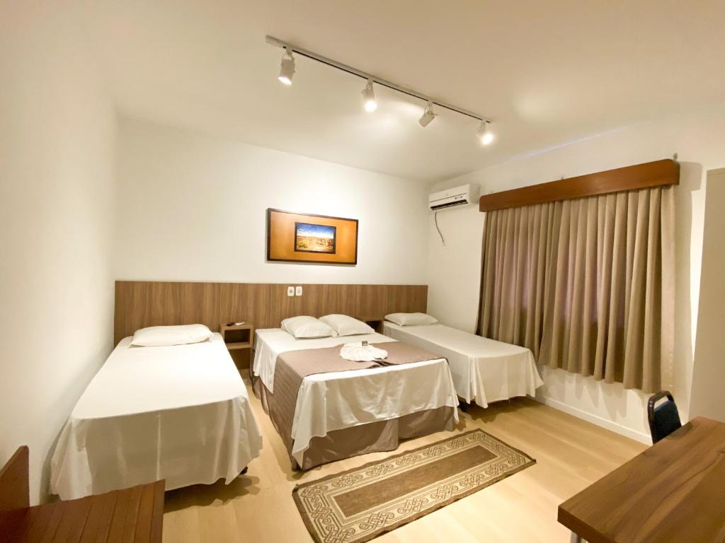 a hospital room with two beds and a window at Hotel Raul's in Gaspar