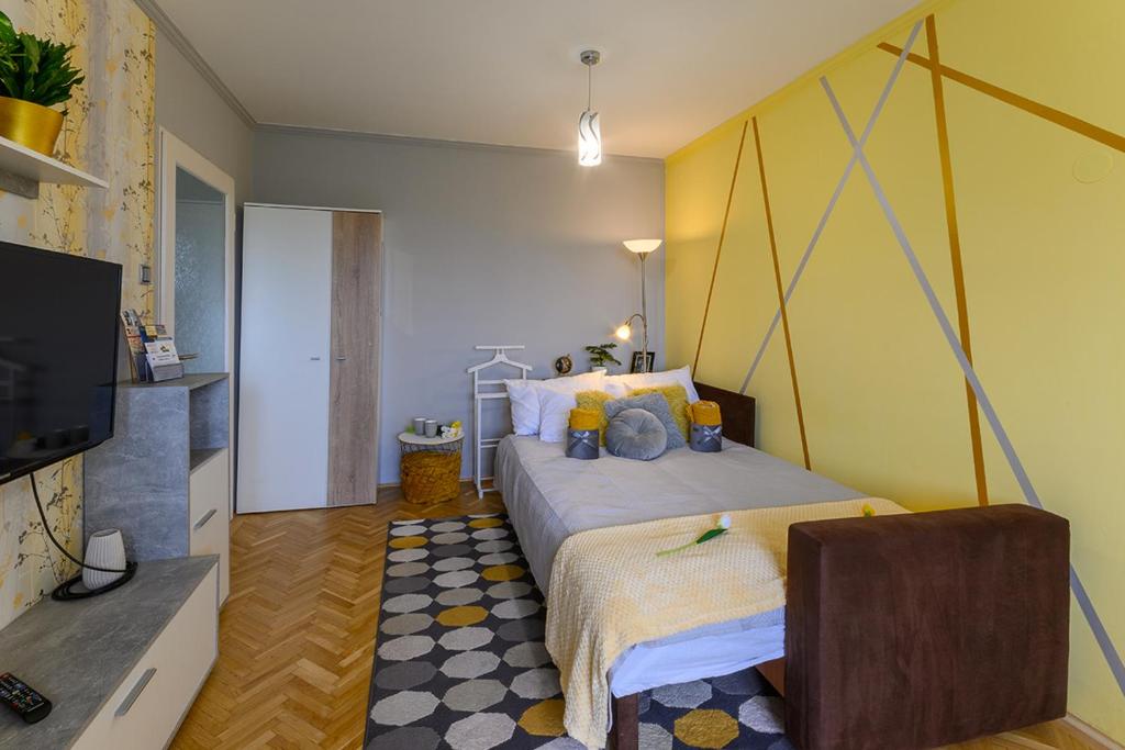 a bedroom with a bed and a flat screen tv at Parkside double room in Budapest