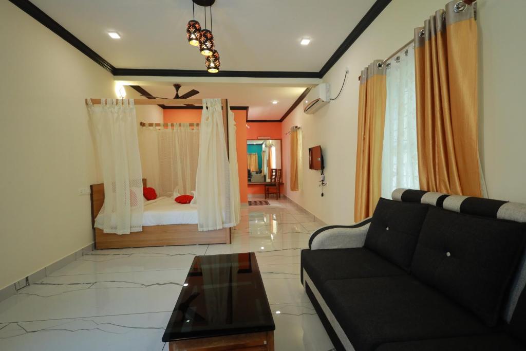 ein Wohnzimmer mit einer Couch und einem Bett in der Unterkunft Lakeway Resorts in Alappuzha