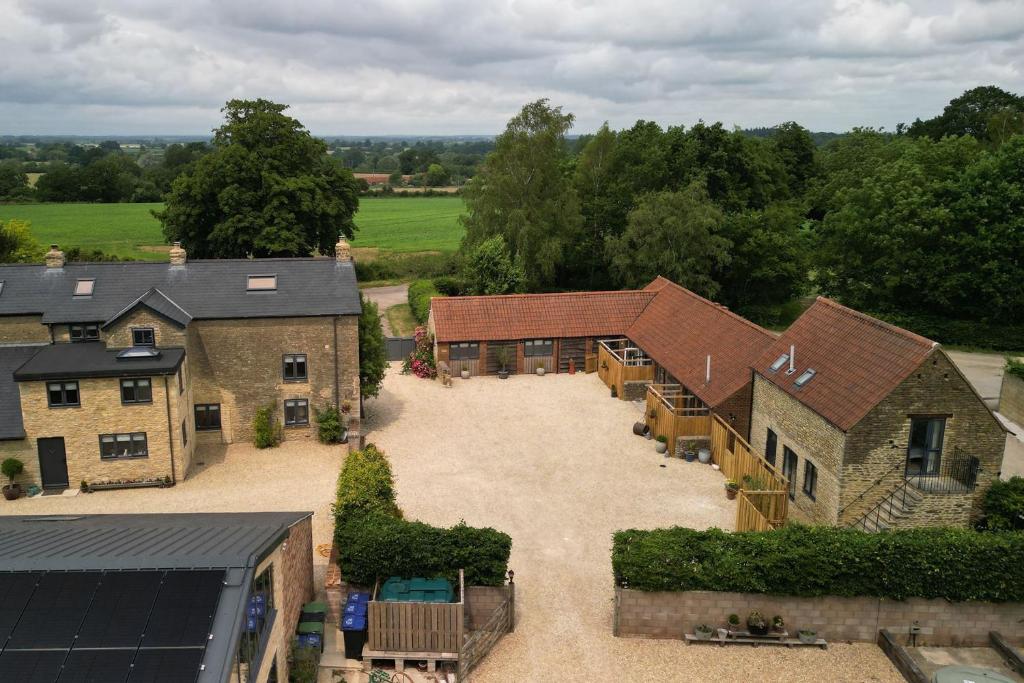 an aerial view of a house with a large courtyard at Farmyard Cottage in Malmesbury