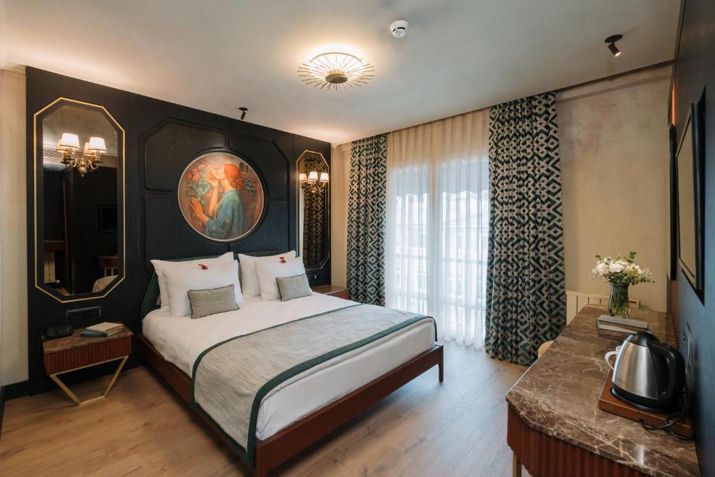 a bedroom with a large bed and a large window at Tria Elegance Istanbul in Istanbul