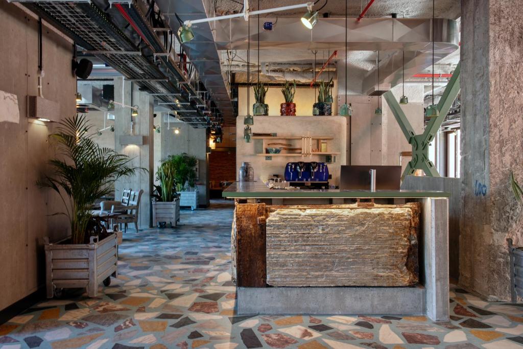 A design-led reception lobby with a central bar and plants.