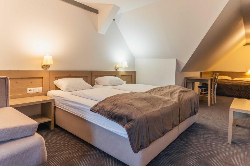 Postelja oz. postelje v sobi nastanitve Hotel Krvavec