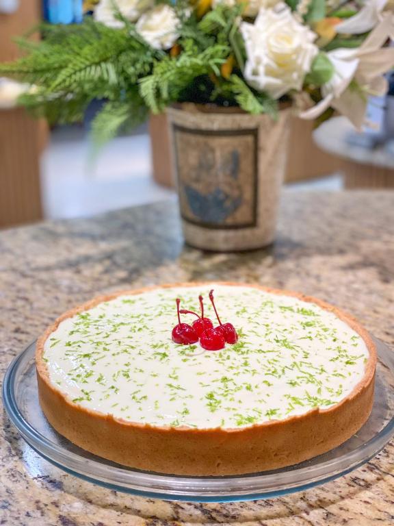 a cake on a table with cherries on top at Hotel Raul's in Gaspar