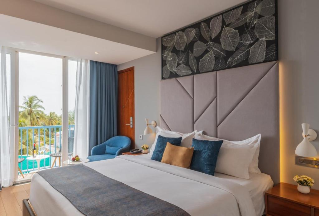 Postel nebo postele na pokoji v ubytování De Mandarin Hotel Goa